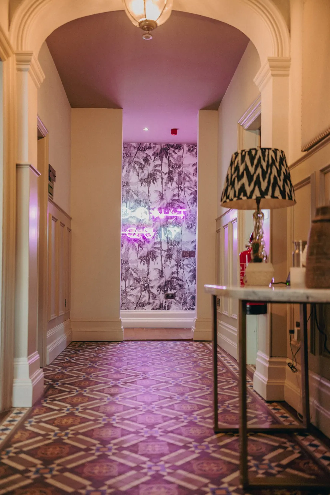 Mutt Mansion's hallway with the neon Don't Quit sign